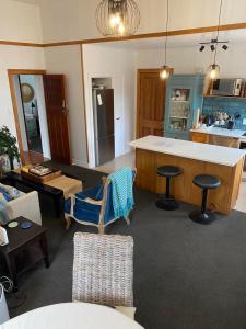 a living room with a kitchen and a counter top at Turret House in Featherston