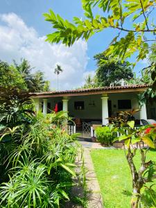 a house with a garden in front of it at Leijay Resort in Galle