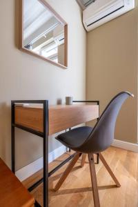 a desk with a chair in a room with a mirror at Stunning Luxury 3 Bedroom Apt in the Heart of Town in Sofia