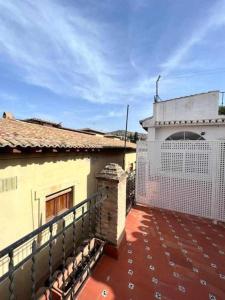 a balcony of a building with a fence on it at Hostal Viena Plaza Nueva in Granada +24 photos