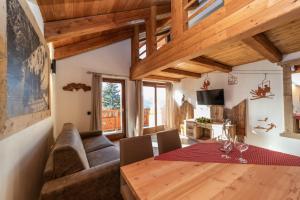 a living room with a table and a couch at Appartamenti ABC Group in Sauze dʼOulx