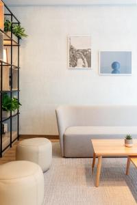 a living room with a couch and a table at IntercityHotel Wien in Vienna