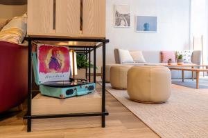a living room with a couch and a table at IntercityHotel Wien in Vienna