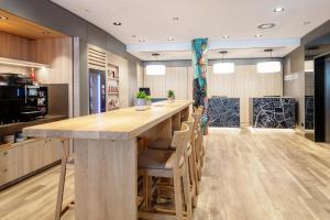 a kitchen with a large wooden table and chairs at IntercityHotel Wien in Vienna