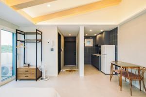 a kitchen and dining room with a table and chairs at Unicorn Jeju in Seogwipo