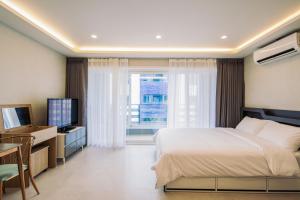 Postel nebo postele na pokoji v ubytování Unicorn Jeju