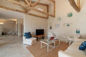 a living room with white furniture and a tv at Villa Angelica with private access to Nora beach in Pula