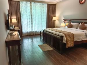 Ένα ή περισσότερα κρεβάτια σε δωμάτιο στο UVA Sands Beach Resort