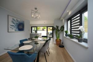 a dining room with a glass table and chairs at Brighton Seaside Retreat in Falmer