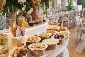 a buffet of bread and pastries on a table at Silverland Mây Hotel in Ho Chi Minh City +112 photos