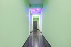 a hallway with a purple light on a wall at FabExpress Laxmi Empire, Siolim in Goa