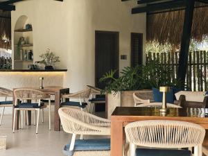a restaurant with tables and chairs and a counter at Sorana Island Villas in Ocoy