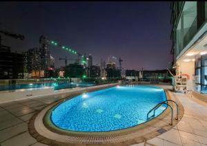 a large swimming pool on top of a building with a city skyline at 151 Residence Jumeirah Gardens in Dubai