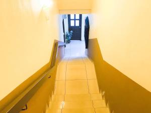 um corredor com escadas que levam até uma porta em Sun Inns Hotel Equine, Seri Kembangan em Seri Kembangan