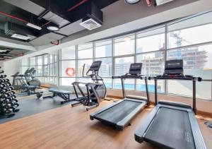 a gym with treadmills and elliptical machines at 151 Residence Jumeirah Gardens in Dubai