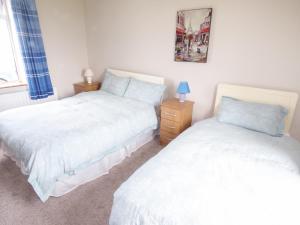 1 dormitorio con 2 camas y una foto en la pared en Ocean View en Louisburgh