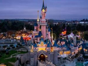 an aerial view of the disney castle at night at Les toits de Bailly Disney Paris in Bailly-Romainvilliers