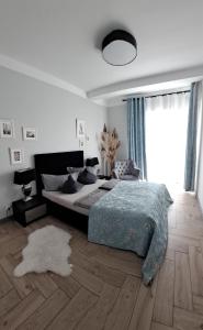 a bedroom with a bed and a large window at Apartament Blue Sky in Lubin