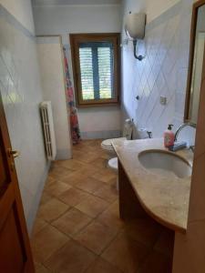 a bathroom with a sink and a toilet at Casa vacanza 70 mq in Valledoria +6 photos