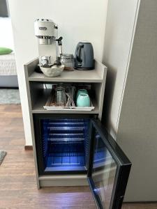 a stand with a coffee maker on top of it at Rooms Lidija in Zagreb
