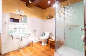 a bathroom with a toilet and a sink and a shower at La maison du Bonheur in Marquixanes