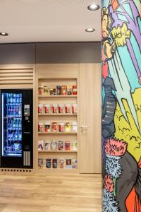 a pharmacy with a painting on the wall at IntercityHotel Wien in Vienna