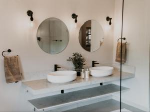 Dos lavabos en un baño con dos espejos en Mambakloof Country Estate, en Vrede 57 fotos más