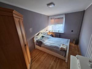 a small bedroom with a bed and a window at Wczasy-Leba in Wicko