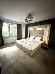 a bedroom with a large bed and a large window at Botabara Del Mar Boutique in Pomorie