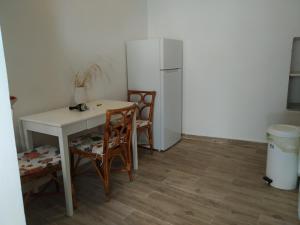 a kitchen with a table and chairs and a refrigerator at Kranai View in Gythio