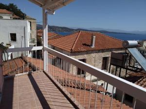 a balcony of a house with a view of the water at Kranai View in Gythio