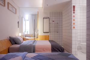Postel nebo postele na pokoji v ubytování TGS Studio Hotel