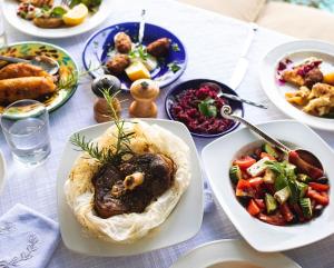 a table topped with plates of food and bowls of food at Apokryfo Traditional Guesthouse in Lofou
