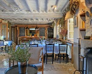 a dining room with tables and chairs in a restaurant at Apokryfo Traditional Guesthouse in Lofou