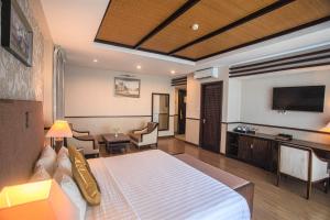 a hotel room with a bed and a television at Seaside Resort Vung Tau in Vung Tau