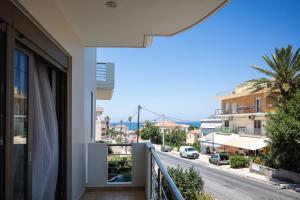 a balcony of a house with a view of a street at JW luxury apartment in Chania