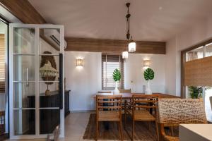 a dining room with a wooden table and chairs at JW luxury apartment in Chania