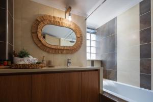 a bathroom with a sink and a mirror at JW luxury apartment in Chania +26 photos