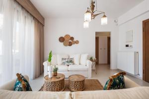 a living room with a couch and a table at JW luxury apartment in Chania