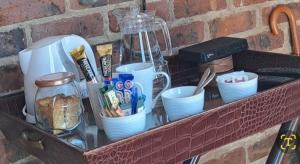 a shelf with cups and dishes on a brick wall at 712@Rest in Dullstroom