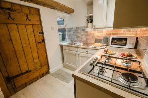 eine Küche mit einem Herd oberer Ofen neben einer Theke in der Unterkunft Swan House in Huddersfield