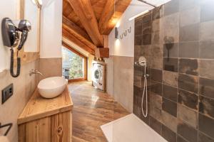 a bathroom with a sink and a shower at Appartamenti ABC Group in Sauze dʼOulx