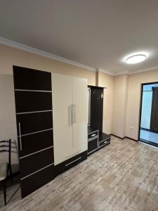 a large room with black and white cabinets at Pirosmani Mini Hotel in Batumi