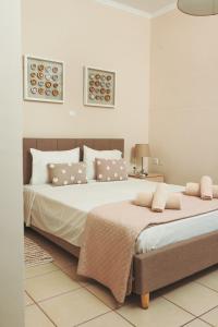 a bedroom with a large bed with two pillows at Plakoures Home in Kounoupidhianá