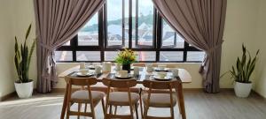 a dining room with a table and chairs in front of a window at Nature Escape Cottage Cameron in Brinchang