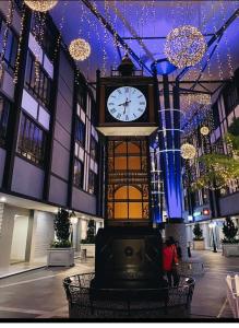 a clock in the middle of a building with lights at Nature Escape Cottage Cameron in Brinchang