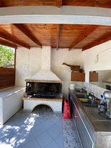 a kitchen with a fireplace in the middle of it at Yfantis Sakis Apartment's in Erateini +42 photos