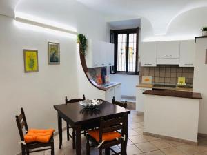 a kitchen with a table and chairs in a room at The House of the poet in Civitavecchia