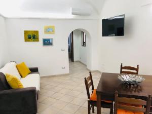 a living room with a table and a couch at The House of the poet in Civitavecchia