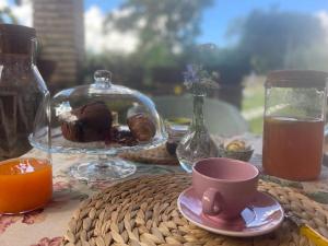 a table with a cup of tea and a bowl of food at Casale la Civetta in Larino